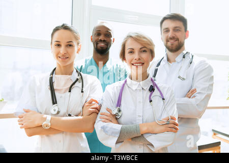 Healthcare people group. Professional male and female doctors posing at hospital office or clinic. Medical technology research institute and doctor staff service concept. Happy smiling models. Stock Photo