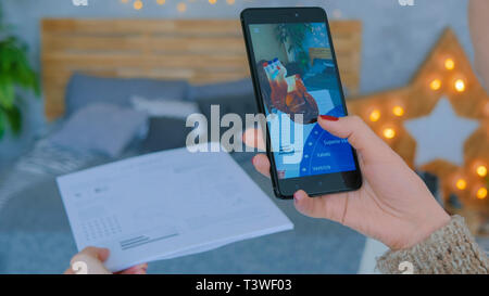 Woman using smartphone with augmented reality app Stock Photo