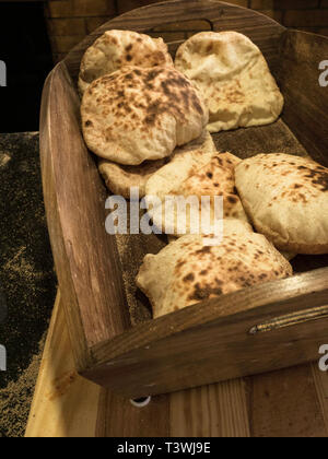 homemade wholegrain pita bread on wooden basket, Traditional and typical food of Arabic cuisine Stock Photo