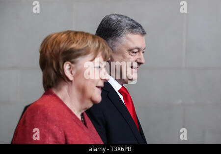 Berlin, Germany. 12th Apr, 2019. Visiting Ukrainian President Petro Poroshenko (R) and German Chancellor Angela Merkel arrive for a joint press conference at the German Chancellery in Berlin, capital of Germany, on April 12, 2019. Credit: Shan Yuqi/Xinhua/Alamy Live News Stock Photo