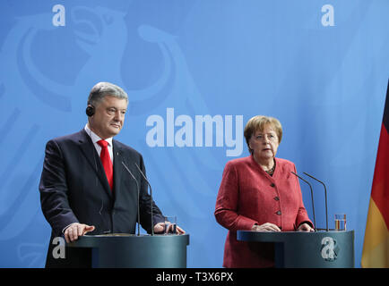 Berlin, Germany. 12th Apr, 2019. German Chancellor Angela Merkel (R) and visiting Ukrainian President Petro Poroshenko attend a joint press conference at the German Chancellery in Berlin, capital of Germany, on April 12, 2019. Credit: Shan Yuqi/Xinhua/Alamy Live News Stock Photo