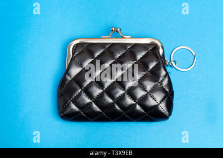 Purse for coins. Black leather wallet on blue background Stock Photo