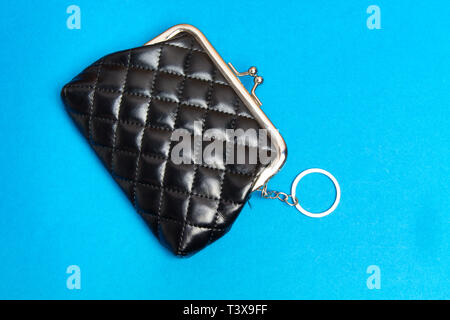 Purse for coins. Black leather wallet on blue background Stock Photo