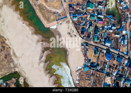 Aerial photography of a small village with villas and cottages, river, beach,forest and roads. Helicopter drone shot Stock Photo