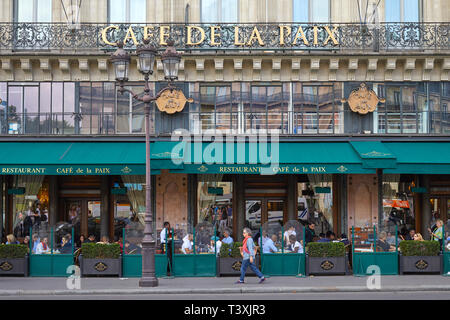 PARIS, FRANCE - JULY 22, 2017: Famous Cafe de la Paix with people and tourists sitting outdoor in Paris, France Stock Photo