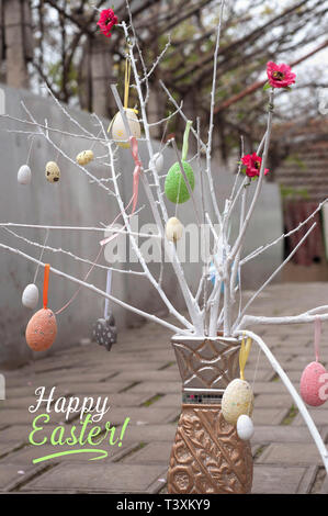 Hand made decorative branches with easter eggs in a vase. Happy Easter Text Template Stock Photo
