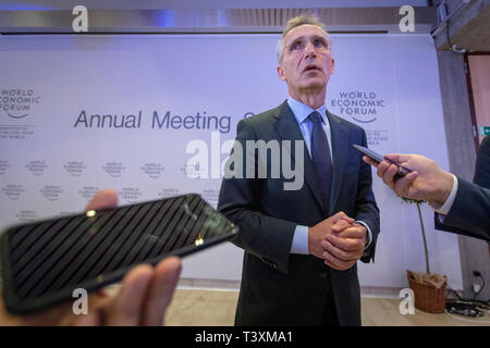 NATO Secretary General Jens Stoltenberg talks to the media at the World Economic Forum in Davos. Stock Photo
