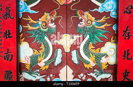 Drawings of dragons at the entrance to the 17th-century Chinese Quan Cong Temple, Hoi An, Vietnam Stock Photo