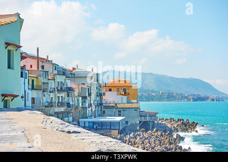 Old houses on rocky coast by the sea in Cefalu, Sicily, Italy Stock Photo