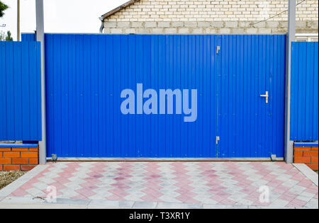Fence and gate from sheets of blue corrugated metal Stock Photo - Alamy