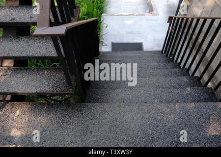 Modern staircase, Staircases in reinforced concrete building, wood railings inside building, New concrete stairs in office building Stock Photo