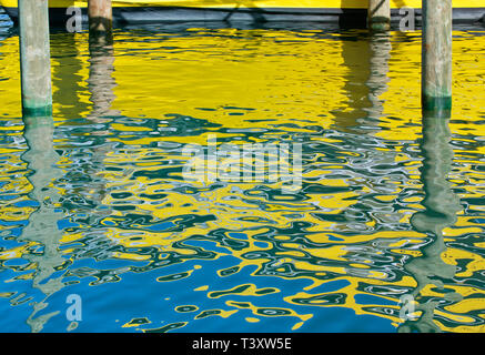 Yellow boat reflected in water Stock Photo