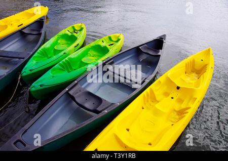 Empty canoes mooring on lake Stock Photo