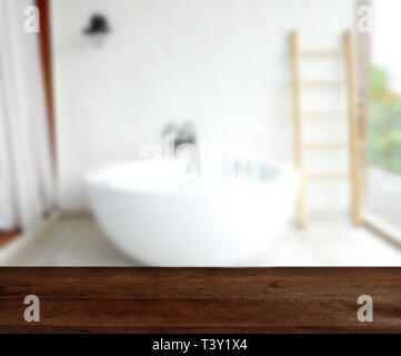 Empty wood table top on luxury bathtub interior background. can be used for display or montage your products Stock Photo