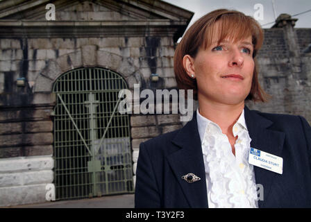 Claudia Sturt, former Governor of HM Prison Dartmoor, UK, outside the main entrance gate (bell over) inside and behind the main gate (barrred) Stock Photo