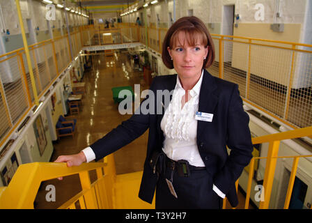 Claudia Sturt, former Governor of HM Prison Dartmoor, UK, outside the main entrance gate (bell over) inside and behind the main gate (barrred) Stock Photo