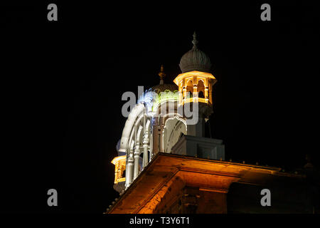 Architectural detail of multi coloured illuminated roofs in the Golden Temple of Amritsar at night, the holiest pilgrimage site of Sikhism, Amritsar Stock Photo