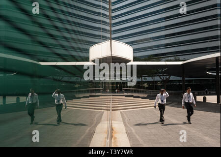 03.02.2018, Singapore, Republic of Singapore, Asia - Two employees are seen at the entrance to The Gateway commercial offices in the downtown core. Stock Photo