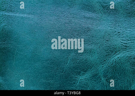 Texture of genuine leather close-up, fashion deep blue-green color. For modern pattern, wallpaper or banner design Stock Photo