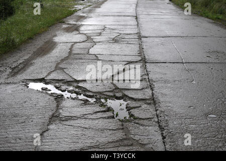 Damaged road in bad condition, Romania, Banat Stock Photo