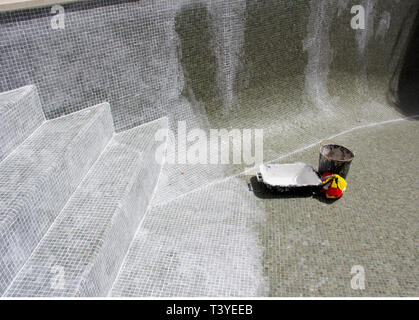 Grouting mosaic tiles in progress on a leaky swimming pool. Stock Photo