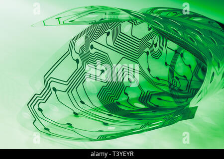 Electronic flex circuit board. Plastic membrane of computer keyboard. Green PCB curled to roll. Round holes, dots, lines. Artistic detail. Electronics. Stock Photo