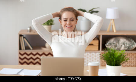 Woman relaxing after finished computer work, looking at screen Stock Photo