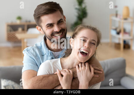 Head shot portrait of happy excited young couple in love at home Stock Photo