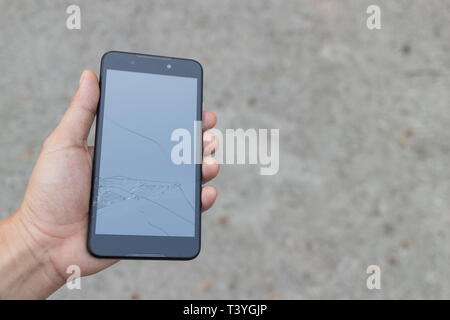 Man holding a Broken Smartphone and touch screen damage broken. Stock Photo