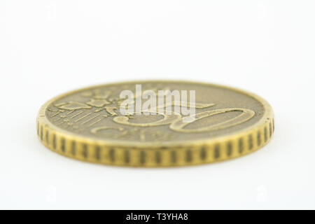 Macro of a fifty euro cents coin on white background. Euro coins. Stock Photo