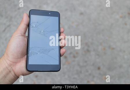 Man holding a Broken Smartphone and touch screen damage broken. Stock Photo