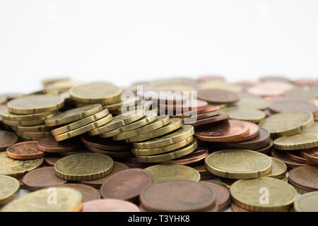 Many euro cents coins on white background. Savings. Stock Photo