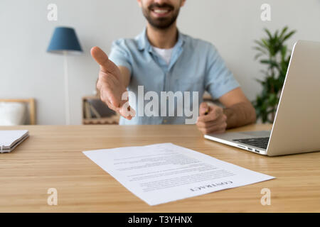 Businessman extending hand for handshake, offer to sign contract Stock Photo