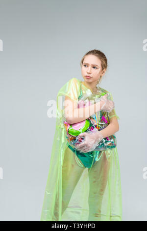 Plastic in hands. Fair-haired young skillful model feeling motivated while posing with plastic in hands Stock Photo