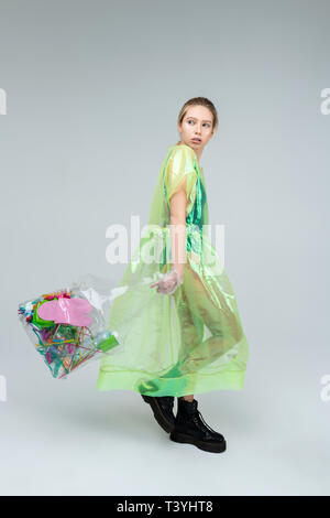 With plastic bag. Skinny promising fair-haired model posing while walking with plastic bag Stock Photo