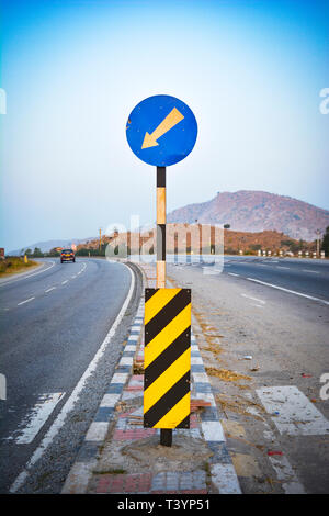 Blue, circular left turn traffic sign Stock Photo