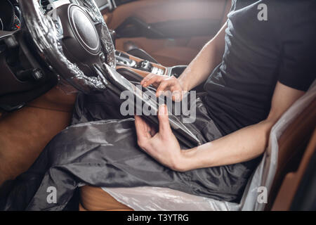Computer diagnostics of electronic systems of the car. Car mechanic maintains a vehicle with the help of a diagnostic tablet computer. Modern Stock Photo