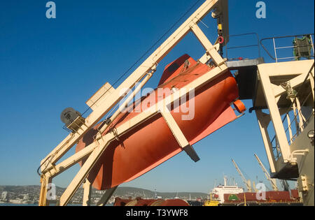 A lifeboat in case of an accident in the port or on a ship. The orange boat. Stock Photo