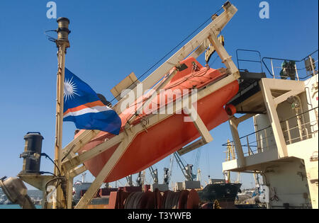 A lifeboat in case of an accident in the port or on a ship. The orange boat. Stock Photo