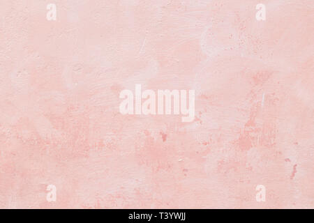 Close-up of a stone or concrete wall painted in pink, paint slightly peeled off. Full frame texture background. Stock Photo