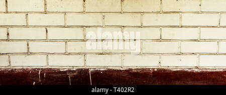 Panoramic canvas of old uneven block shape white and red color wide brick wall background of a vintage house facade. Modern style design decorative id Stock Photo