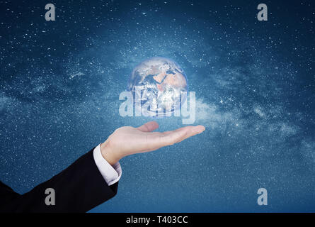 Businessman showing the world on hand, on blue starry space background. Element of this image are furnished by NASA Stock Photo