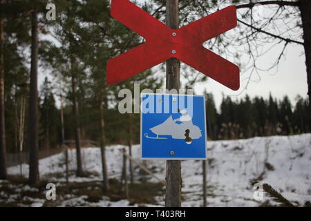 No snow scooter driving sign in a forest in winter Stock Photo