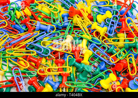 Multicolored paper clips and plastic drawing pins Stock Photo