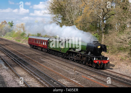 The Flying Scotsman, famous steam train or locomotive, travelling through Hampshire countryside in April 2019, UK. Stock Photo