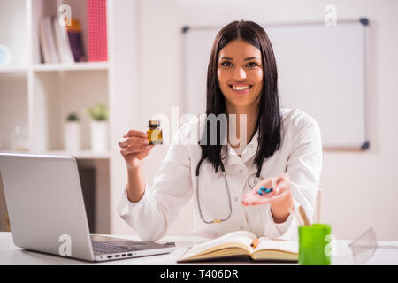 Young doctor is talking about taking pills. Stock Photo