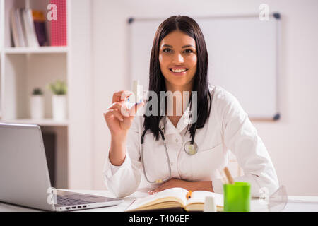 Young doctor is talking about using inhaler. Stock Photo