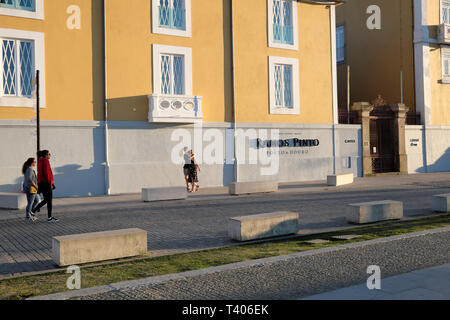 Young couple walking along a Gaia street past a building with Ramos Pinto winery sign in Vila Nova de Gaia in Porto, Portugal Europe EU  KATHY DEWITT Stock Photo