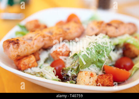 Caesar salad with grilled chicken fillet, parmesan cheese and croutons Stock Photo