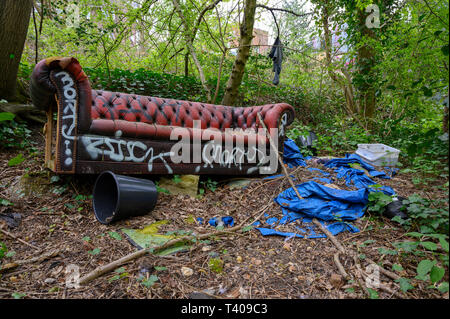 A fly-tipped Chesterfield sofa in Queens Wood - Highgate - London Stock Photo